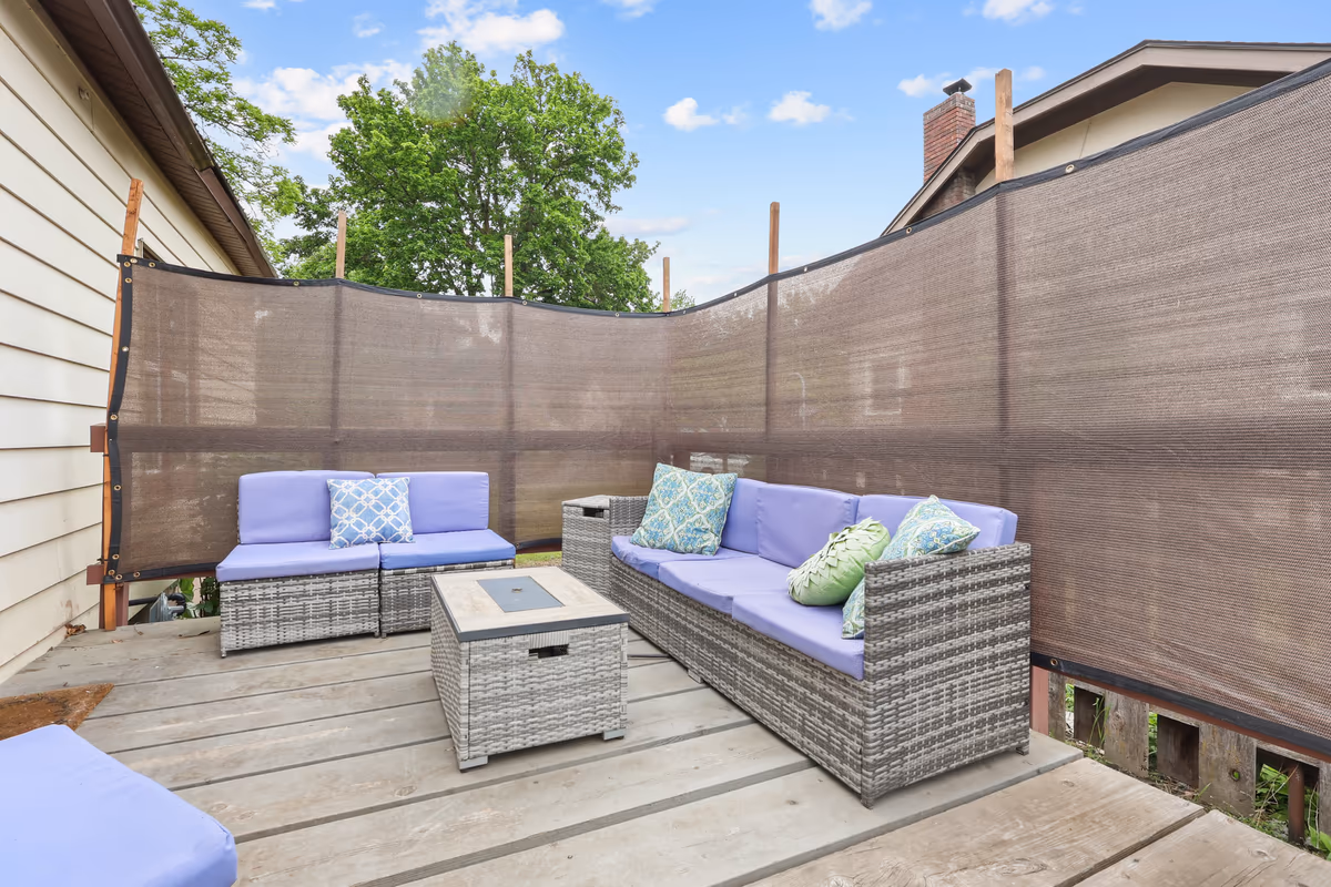 Backyard patio with lounge seating and a fire-pit table