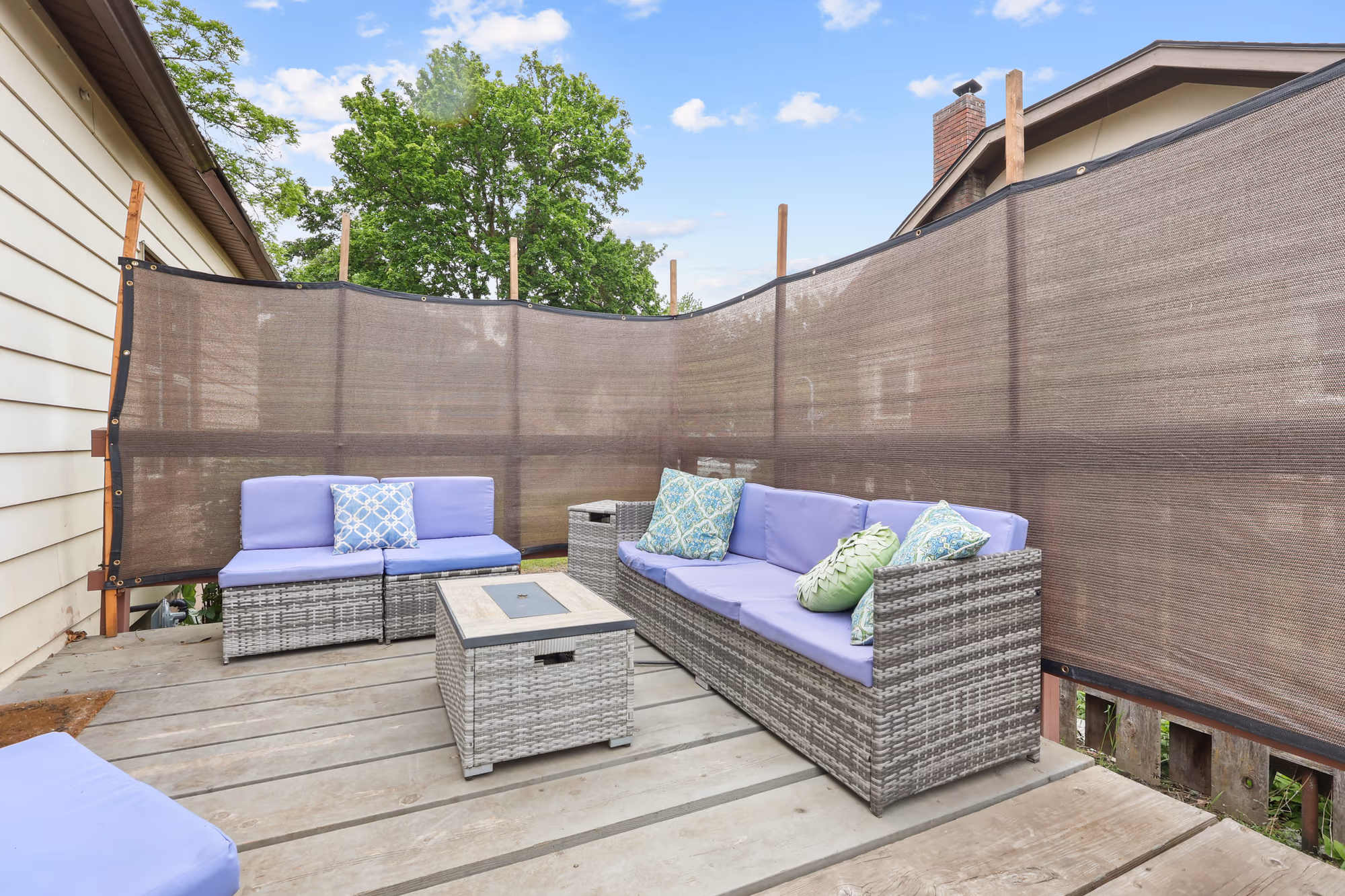 Backyard patio with lounge seating and a fire-pit table