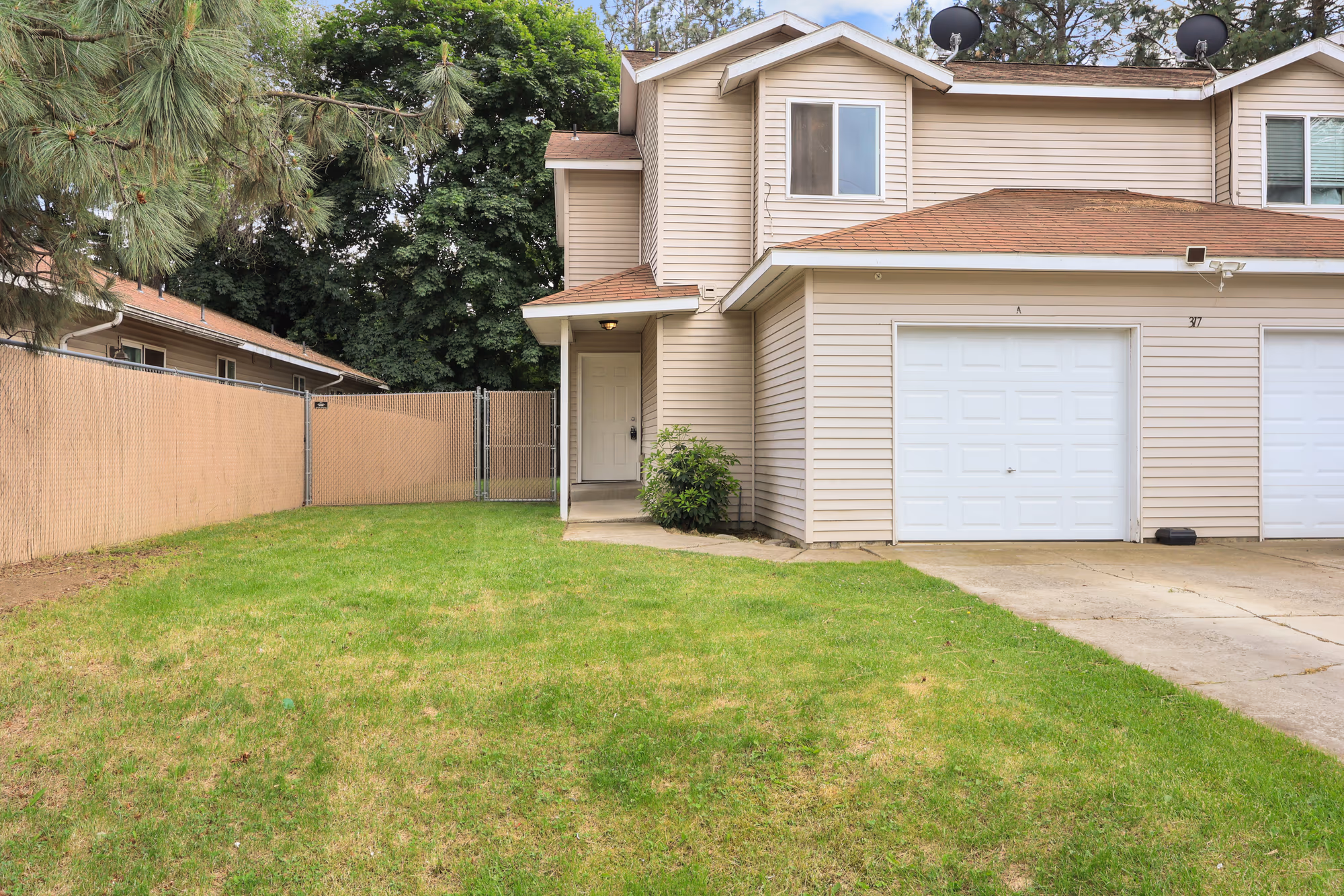 Two-story home with a driveway on a sunny day