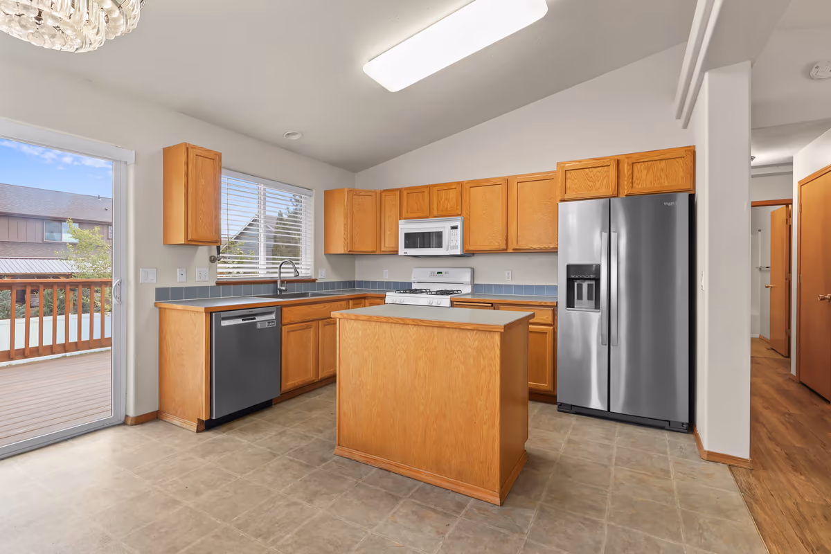 Bright vaulted kitchen with an island and stainless appliances
