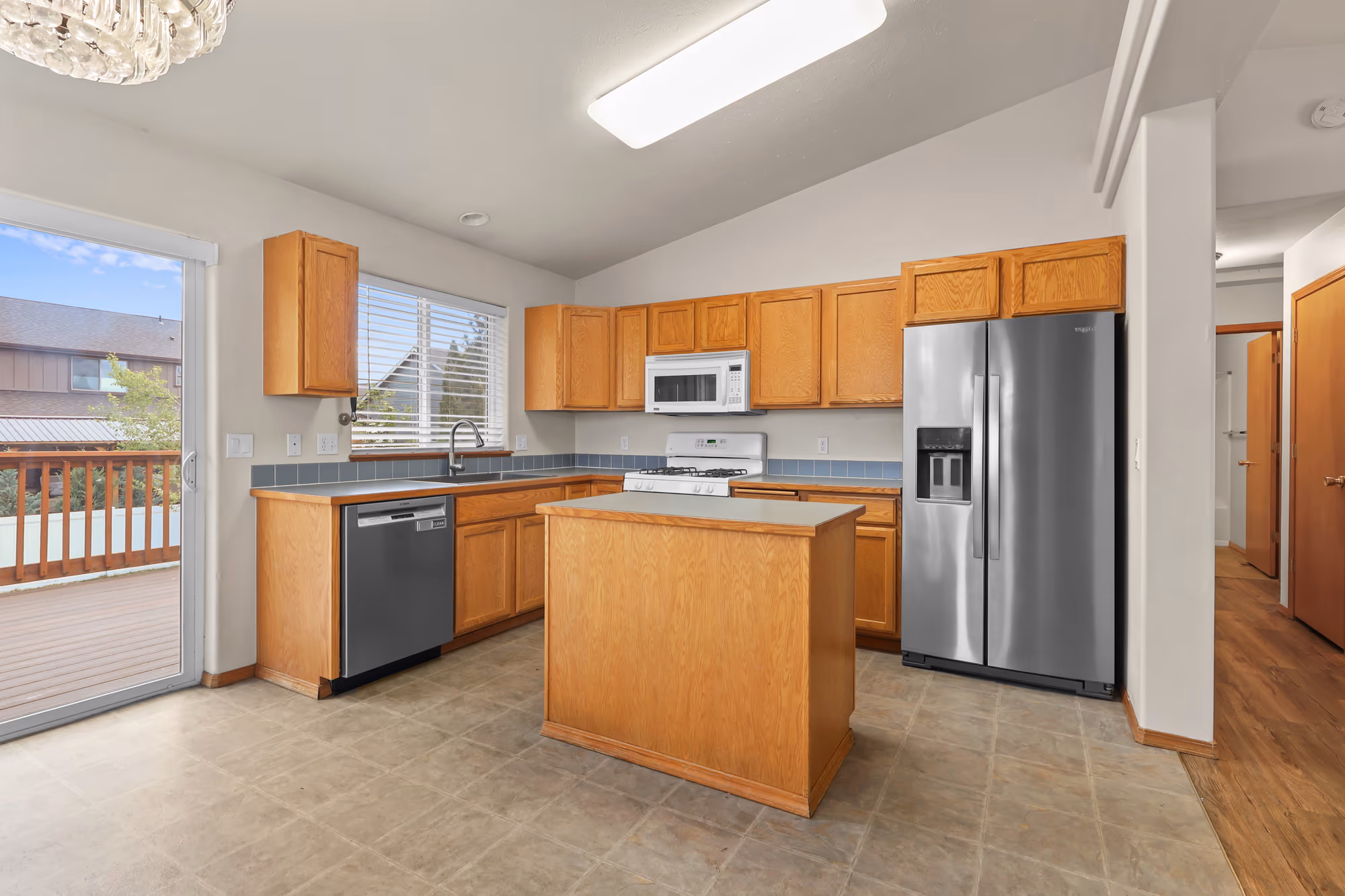Bright vaulted kitchen with an island and stainless appliances