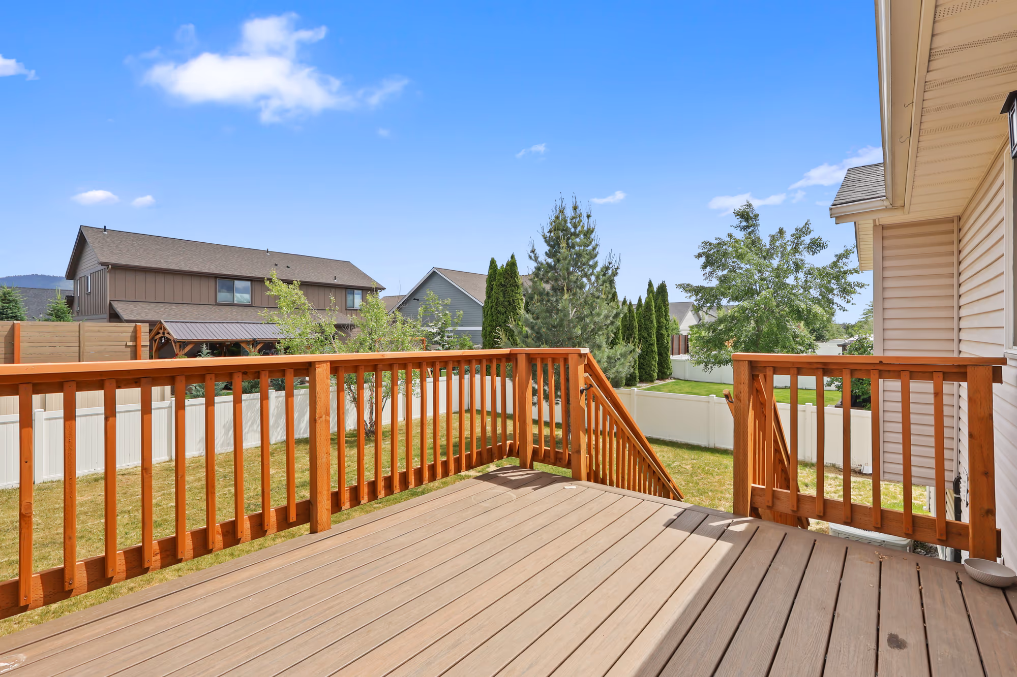 Elevated deck overlooking the backyard and neighborhood