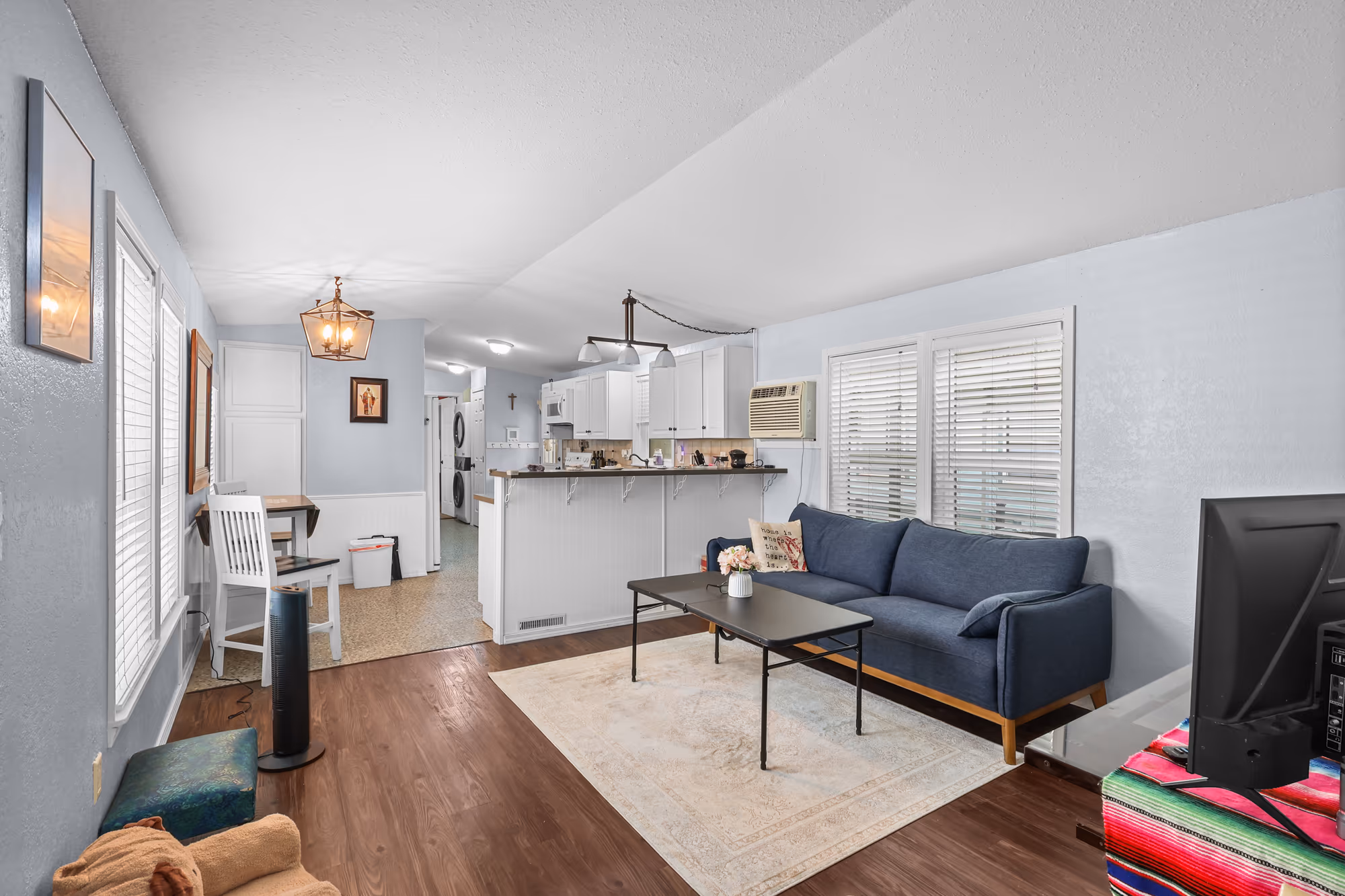 Open living room and kitchen with wood-look floors