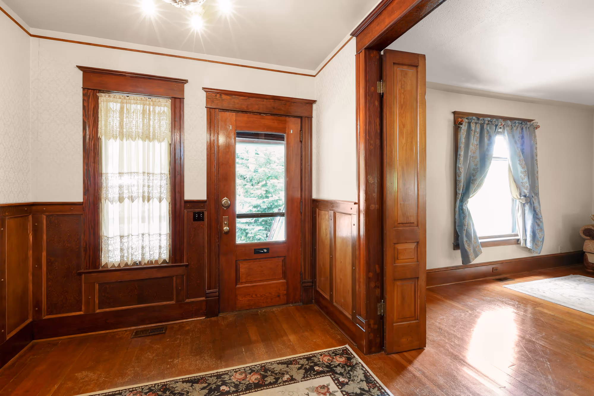 Entry foyer with original wood wainscoting and trim