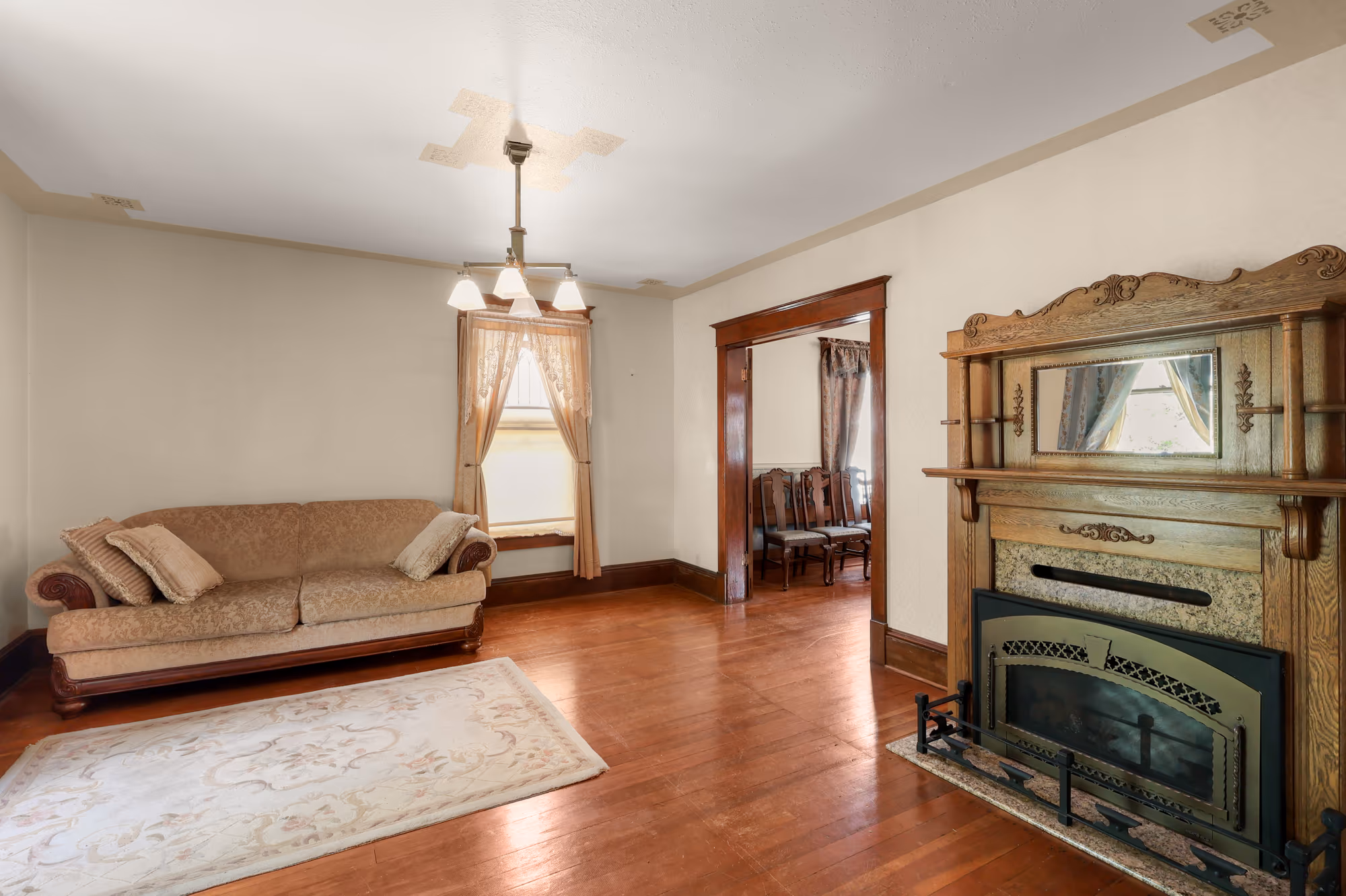 Parlor with an antique carved fireplace mantel