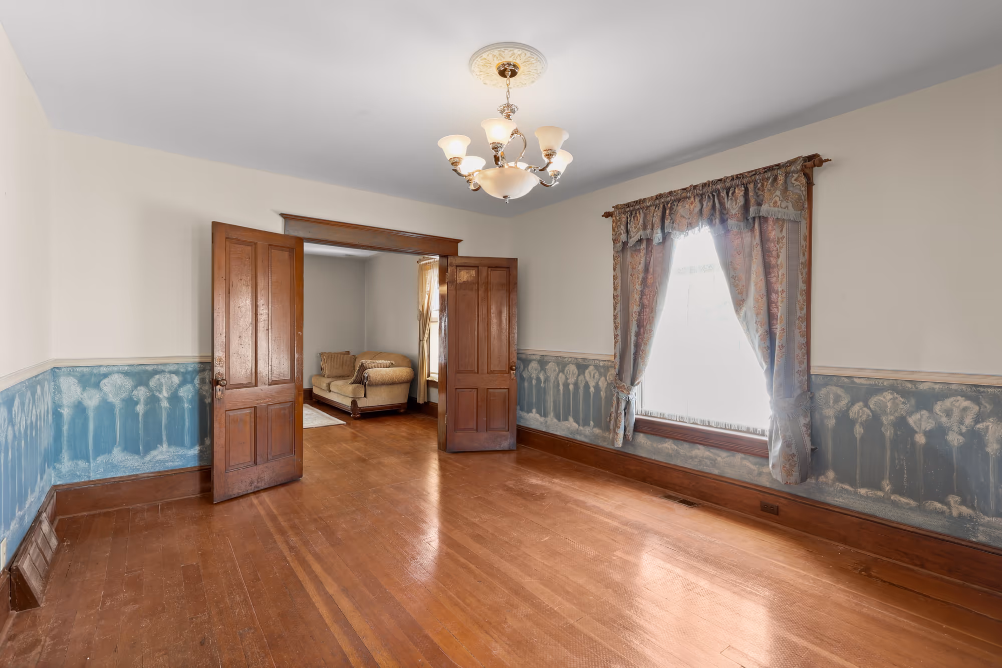 Dining room with stenciled wainscot and hardwood floors