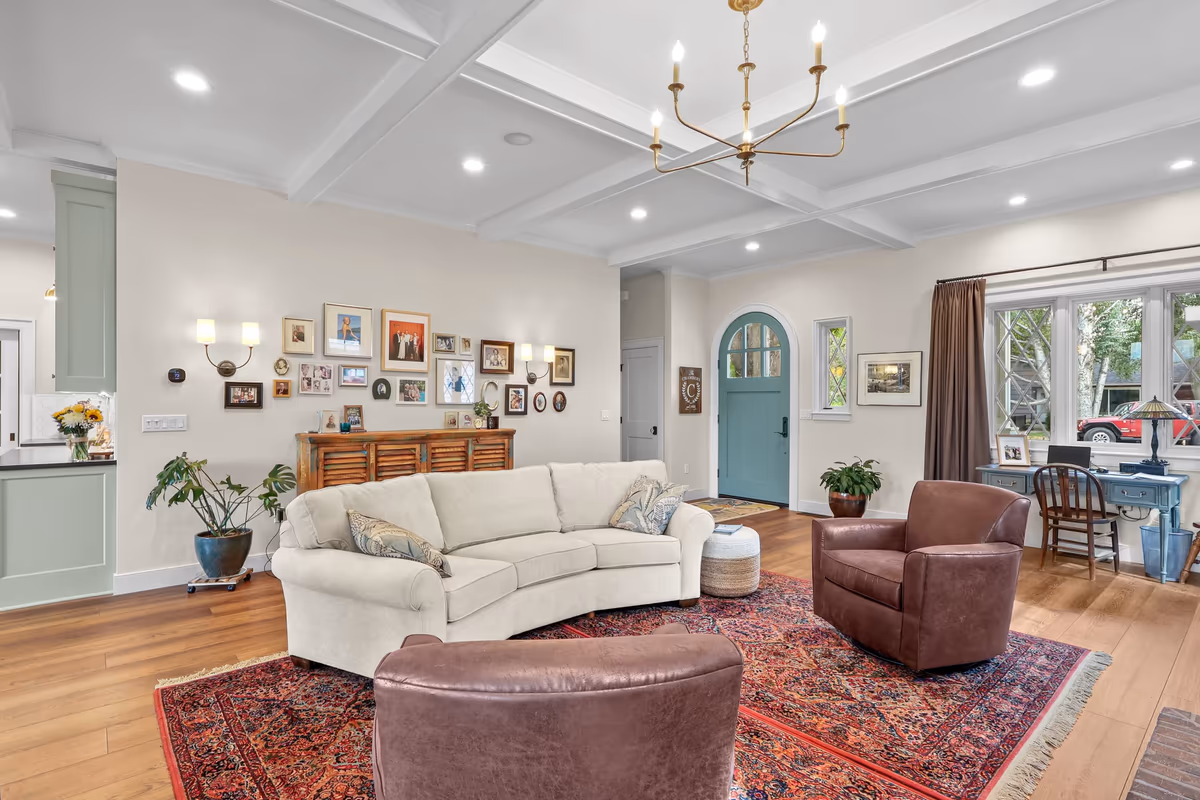 Reverse view of the living-room seating area and white ceiling beams